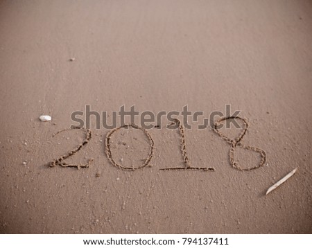 Number 2018 written on sand