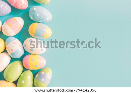 Coloeful easter eggs on pastel color background with space.