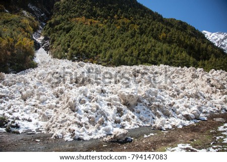 An avalanche on the tourist's trail at trekking in Nepal. Annapurna Circuit. The trail near Lower Pisang