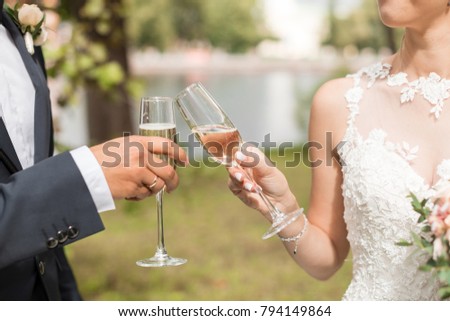 Bride and Groom toasting. Champagne glasses. Horizontal format. Close up picture.