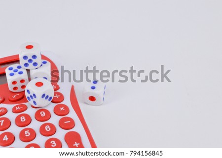 Conceptual image calculator with dice on white background. Selective focus.