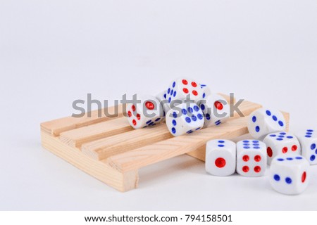 Conceptual image dice on wooden pallet with white background. Selective focus.