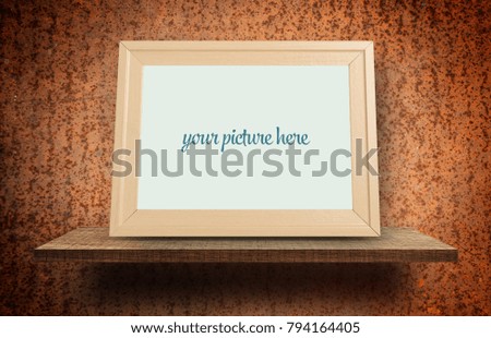 Empty wooden photo frame mock up on rustic metal background