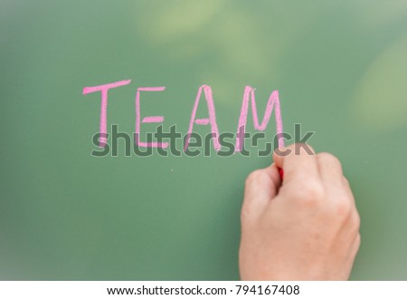 Selective focus, Word Team written on blackboard, Teamwork concept.