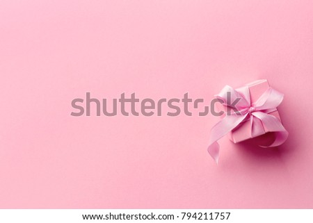 Pink gift box from top view. Space for text