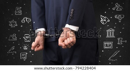 Chalk drawn courthouse symbols and close handcuffed hands in suit

