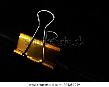 
color gold clips. Black background.