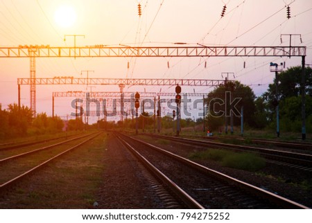 Rails, receding into the distance at sunset