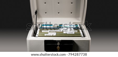 Close up of a well organized home filing system with tabs for each subject in fireproof safe Royalty-Free Stock Photo #794287738
