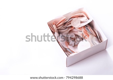 Confetti popping out from blue gift box isolated on white background