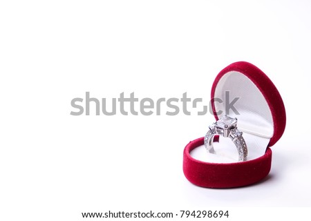 Beautiful shiny platinum engagement ring with big gem diamond in rich red velvet box isolated on white background. st Valentine's Day proposal gesture present. Copy space, front top view, background Royalty-Free Stock Photo #794298694