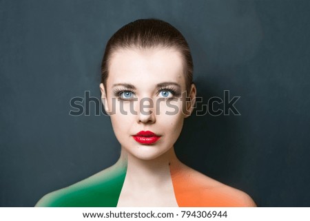 Portrait of woman with Ireland flag painted on the shoulders