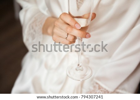 Woman holding a glass of champagne. Bride. Wedding dress. Close up picture