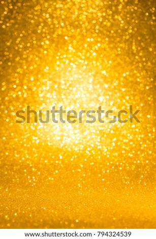 Shiny defocused sparkling golden glittering background.