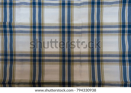 Background of a tablecloth or napkin checkered on blue, white and orange. Fabric for picnics with nothing in it.