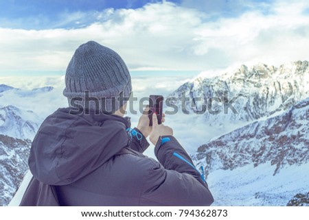 Close-up Of Person Hand With No Wifi Signal On Mobile Phone In Snowy Mountain
