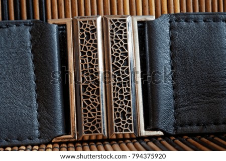 Fashion steel Belt bulk isolated on wooden background.