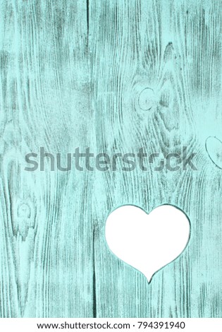 White heart carved in a blue wooden board. Background. Postcard, valentine.