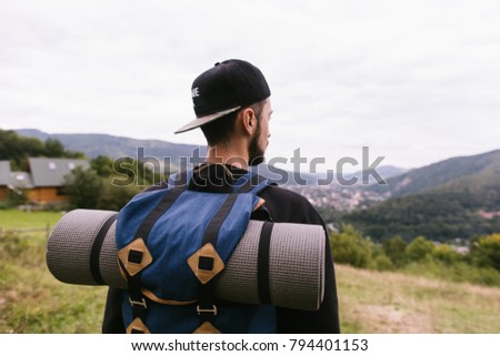 Tourist, guy with a backpack in the mountains