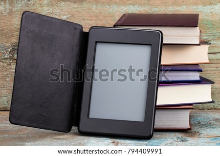 E-book and old books. New technologies in book publishing. Royalty-Free Stock Photo #794409991