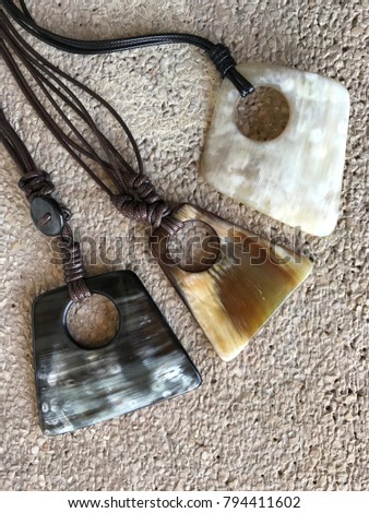 Costume jewelry and accessories, necklace 3 piece in bull and buffalo horn with macramé made in synthetic cord, unisex element, photo with small stone bottom and focused rustic look