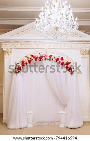 The wedding photographer's area is decorated with tulle and flowers