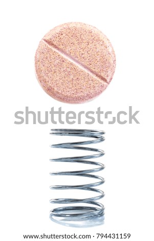 power and energy concept a metal spring, with an effervescent tablet of vitamin C,