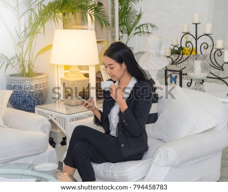Portrait of an attractive young asian business woman with cell phone or smart phone at home office,background is green garden. Portrait business people for new start up business and financial concept