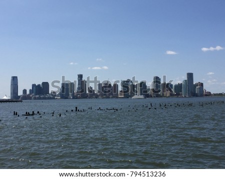 A view of Jersey City, New Jersey and the Hudson River on a clear day as seen from New York City, New York