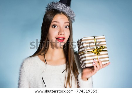 lovely surprised girl received a gift for the new year from friends