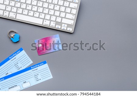 Planning journey and buy tickets. Documents near bank card and keyboard on grey background top view copy space