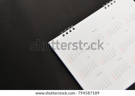 Close up white calendar on black background.