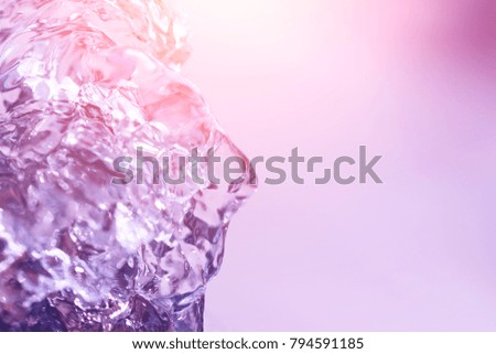 Flow of clear water in pink light, abstract background, texture