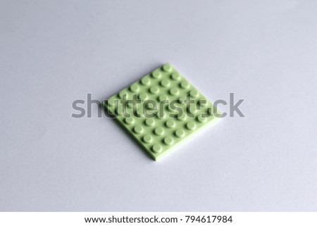 Green plastic building toy block isolated on white background