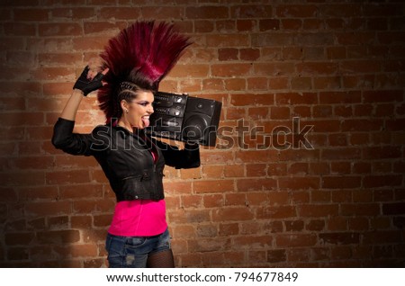 Young punk girl on brick wall background