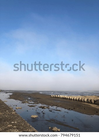The fog spreading on the sea in warm winter