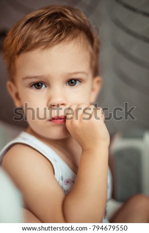 Happy 3 years old baby boy. Kid is smiling, grinning. Portrait of adorable little boy lookign at camera with smiling face, Child relaxing at home in a sunny day, Healthy or Happy children concept