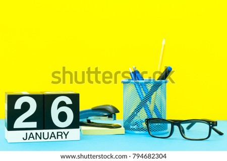 January 26th. Day 26 of january month, calendar on yellow background with office supplies. Winter time