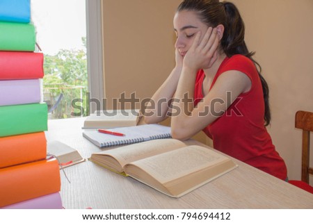Student, Young Girl working on his homework. Portrait of pretty girl high school student studying and writing