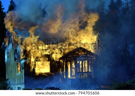 Dark and sad picture of burning house.