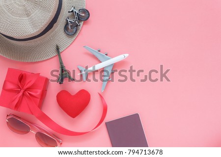 Flat lay image of accessory clothing man or women to plan travel in valentines day background concept.Passport & clothes with many items in holiday season.Table top view several object on pink paper.