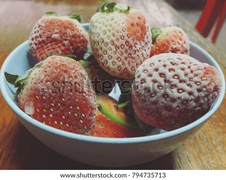 Strawberries frozen in a cup
