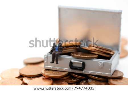 Miniature people : businessman sitting on Money or coins in Chest box isolated on white background,business concept.