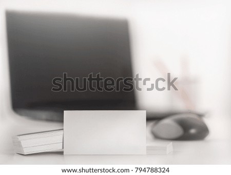 Business concept.White Blank business card at workplace with blur background.