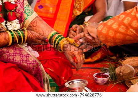 Indian candid wedding photography .focus on hands .couple performed rituals of hindu tradition .