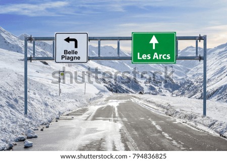 France ski town Belle Plagne and Les Arcs road big sign with a lot of snow and mountain sky 