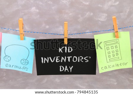 Notes hang on clothes pegs with drawings of children's inventions - popsikl, Earmuffs, calculator on a gray background. Text - Kid Inventors' Day