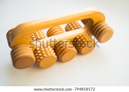 wooden roller for back massage, and for neck isolated on white background. wellness concept.roller masseur for removal of muscular fatigue . health spa. Selective focus.Copy space