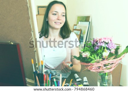Positive young artist in the process of creating a new picture