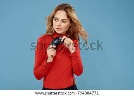 woman with a joystick on a blue background                               